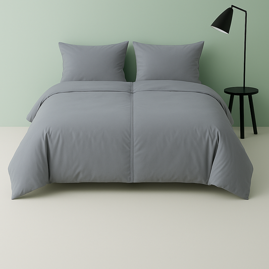 Settoo DuoCover Zipped - double duvet cover, in soft Gray bedding set on a bed against a green wall with a black lamp.