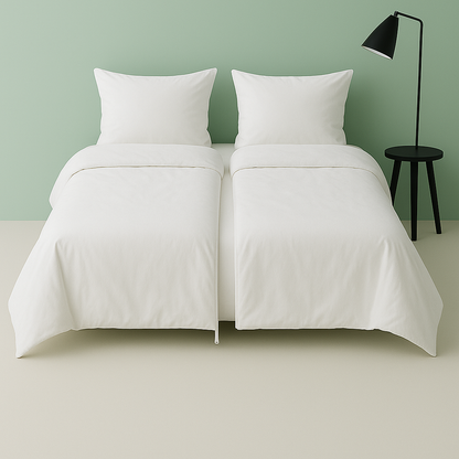 Settoo DuoCover unzipped - 2 single duvet covers and matching pillows set on a bed with a green wall and black lamp in the background